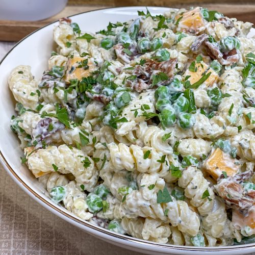 Creamy Bacon Ranch Pasta Salad combines crisp bacon, cheddar cheese, tender pasta with peas for a juicy bite with a creamy ranch dressing. A great summer pasta salad for any occasion.