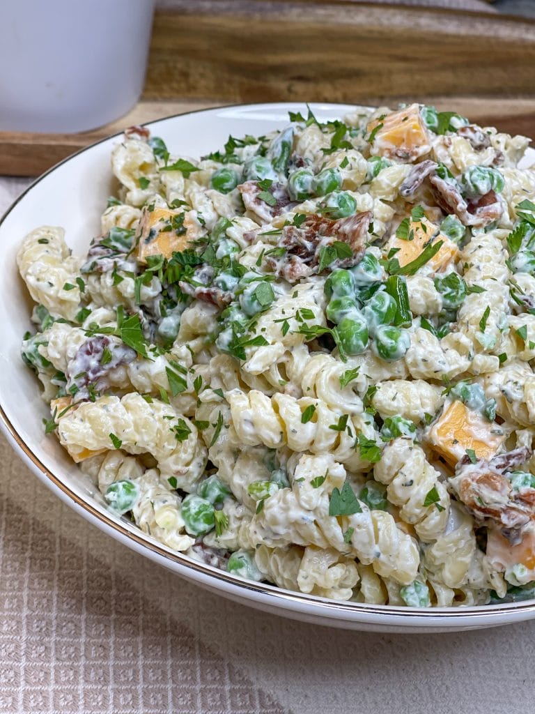 Creamy Bacon Ranch Pasta Salad combines crisp bacon, cheddar cheese, tender pasta with peas for a juicy bite with a creamy ranch dressing. A great summer pasta salad for any occasion.