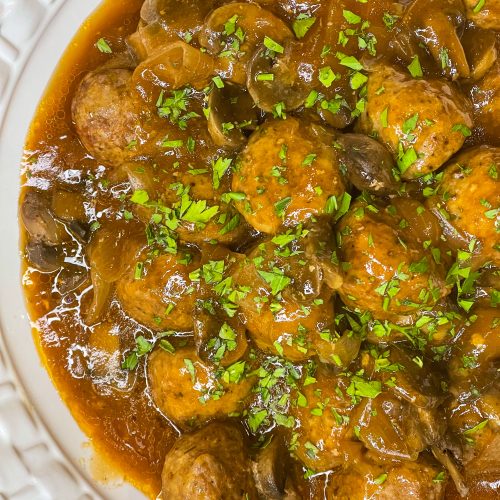 Crock Pot Salisbury Meatballs are juicy meatballs smothered in a flavorful brown gravy served over a big pile of fluffy mashed potatoes. The best thing about this recipe is that you can use homemade or frozen meatballs.