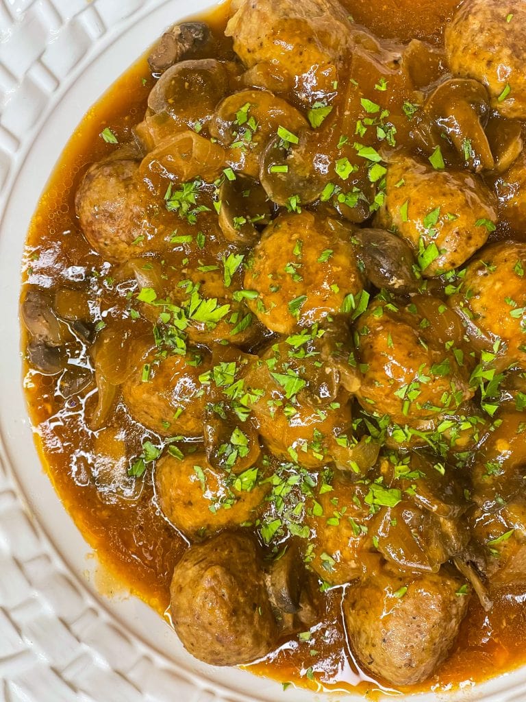 Crock Pot Salisbury Meatballs are juicy meatballs smothered in a flavorful brown gravy served over a big pile of fluffy mashed potatoes. The best thing about this recipe is that you can use homemade or frozen meatballs. 