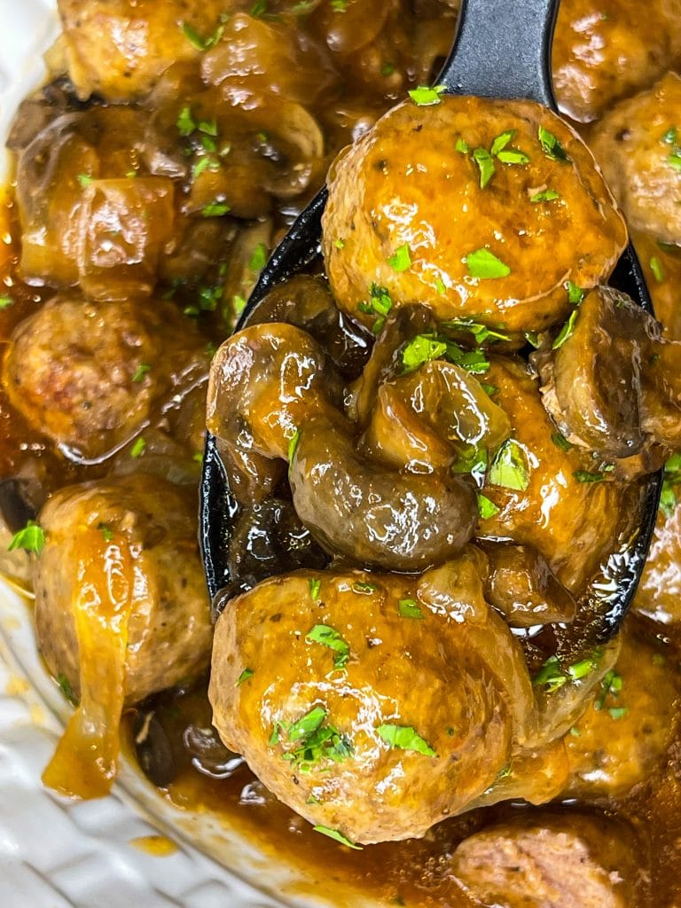 Crock Pot Salisbury Meatballs are juicy meatballs smothered in a flavorful brown gravy served over a big pile of fluffy mashed potatoes. The best thing about this recipe is that you can use homemade or frozen meatballs.