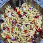 If you love the flavors of the Mediterranean, you'll love this Greek Pasta Salad with tender pasta, kalamata olives, red peppers, cucumbers, juicy tomatoes, tangy red onion, and creamy feta cheese all tossed in an herby olive oil dressing.