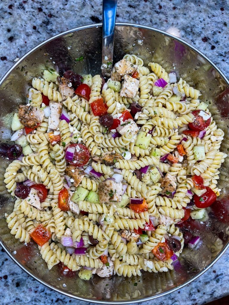 If you love the flavors of the Mediterranean, you'll love this Greek Pasta Salad with tender pasta, kalamata olives, red peppers, cucumbers, juicy tomatoes, tangy red onion, and creamy feta cheese all tossed in an herby olive oil dressing.