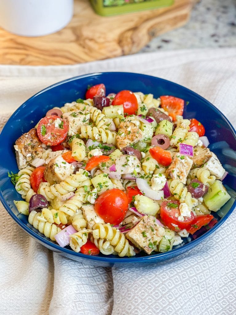 If you love the flavors of the Mediterranean, you'll love this Greek Pasta Salad with tender pasta, kalamata olives, red peppers, cucumbers, juicy tomatoes, tangy red onion, and creamy feta cheese all tossed in an herby olive oil dressing.