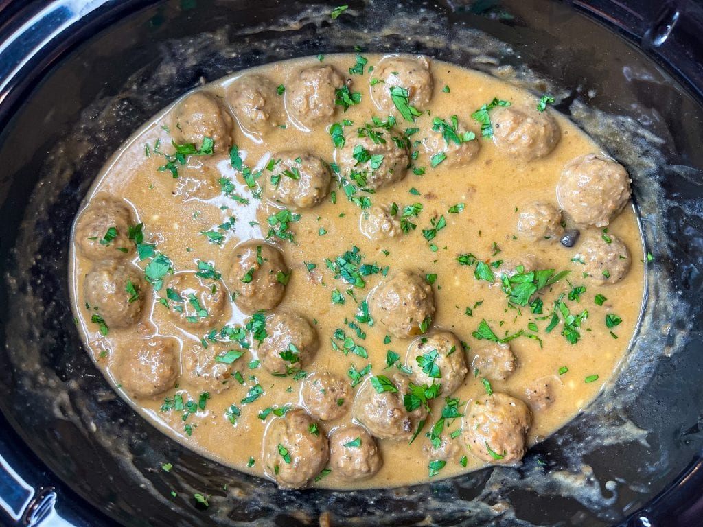 Our family loves Swedish Meatballs. The meatballs are so juicy and the sauce is velvety smooth; really what's not to love! Making Swedish meatballs in the crock pot is so easy. It's a dump and go type of recipe with frozen meatballs, for a short cut, and simple ingredients, like cream of mushroom soup, French onion soup, beef broth, and sour cream.