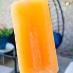 These adult only winesicles are made with 3 simple ingredients blended together-peaches (fresh, frozen, or canned), orange juice, and white wine. They are quick and simple to make and are my favorite way to cool off in the summer. Picture it- the hot sun, a pool, and a cold peach winesicle. Yes, please!