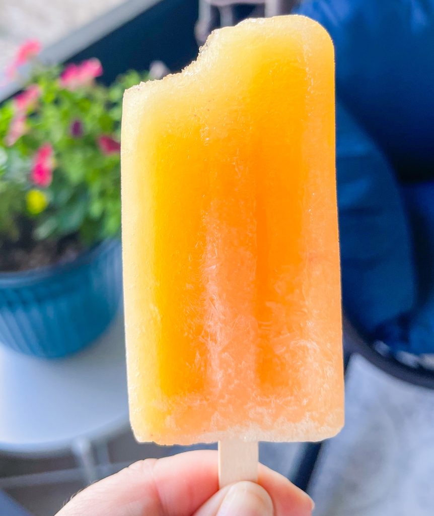 These adult only winesicles are made with 3 simple ingredients blended together-peaches (fresh, frozen, or canned), orange juice, and white wine. They are quick and simple to make and are my favorite way to cool off in the summer. Picture it- the hot sun, a pool, and a cold peach winesicle. Yes, please!