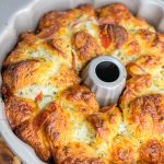 The best snack or appetizer, Pepperoni Pizza Monkey Bread is buttery biscuit dough, pepperoni, and mozzarella cheese stuffed into a bundt pan and baked to golden perfection.