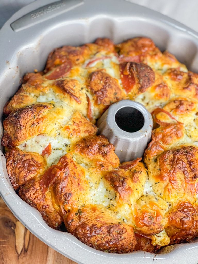 The best snack or appetizer, Pepperoni Pizza Monkey Bread is buttery biscuit dough, pepperoni, and mozzarella cheese stuffed into a bundt pan and baked to golden perfection.