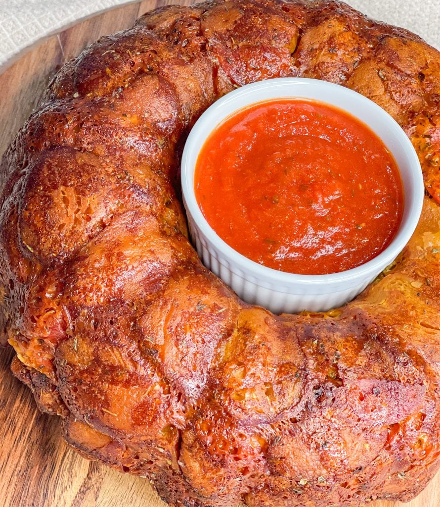 The best snack or appetizer, Pepperoni Pizza Monkey Bread is buttery biscuit dough, pepperoni, and mozzarella cheese stuffed into a bundt pan and baked to golden perfection.