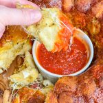 The best snack or appetizer, Pepperoni Pizza Monkey Bread is buttery biscuit dough, pepperoni, and mozzarella cheese stuffed into a bundt pan and baked to golden perfection.