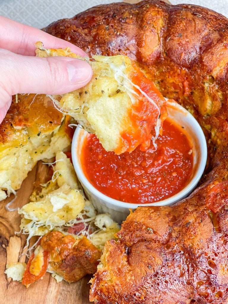 The best snack or appetizer, Pepperoni Pizza Monkey Bread is buttery biscuit dough, pepperoni, and mozzarella cheese stuffed into a bundt pan and baked to golden perfection. 