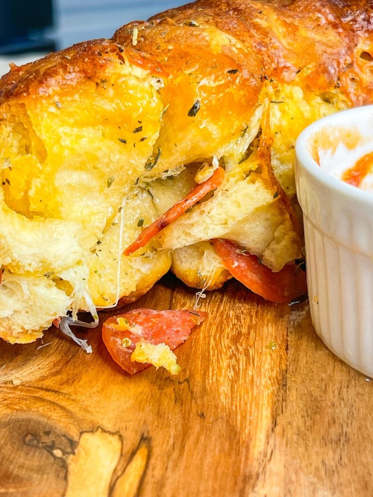 The best snack or appetizer, Pepperoni Pizza Monkey Bread is buttery biscuit dough, pepperoni, and mozzarella cheese stuffed into a bundt pan and baked to golden perfection.