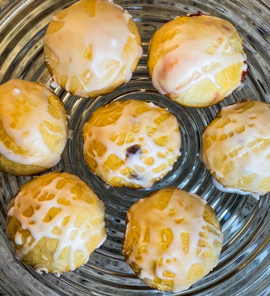 Fruity Pie Biscuit Bombs are delicious little nuggets of blueberry and cherry pie filling (or any fruit pie filling you like!) stuffed into a flaky biscuit round, baked, and covered in a powdered sugar glaze.