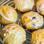 Fruity Pie Biscuit Bombs are delicious little nuggets of blueberry and cherry pie filling (or any fruit pie filling you like!) stuffed into a flaky biscuit round, baked, and covered in a powdered sugar glaze.