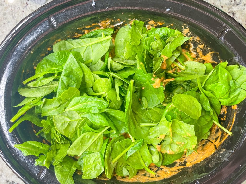 The whole family is going to love this easy weeknight Crock Pot Cheesy Tortellini dinner. It's creamy, rich and filling with tortellini, cream cheese, a hearty meat sauce and spinach.