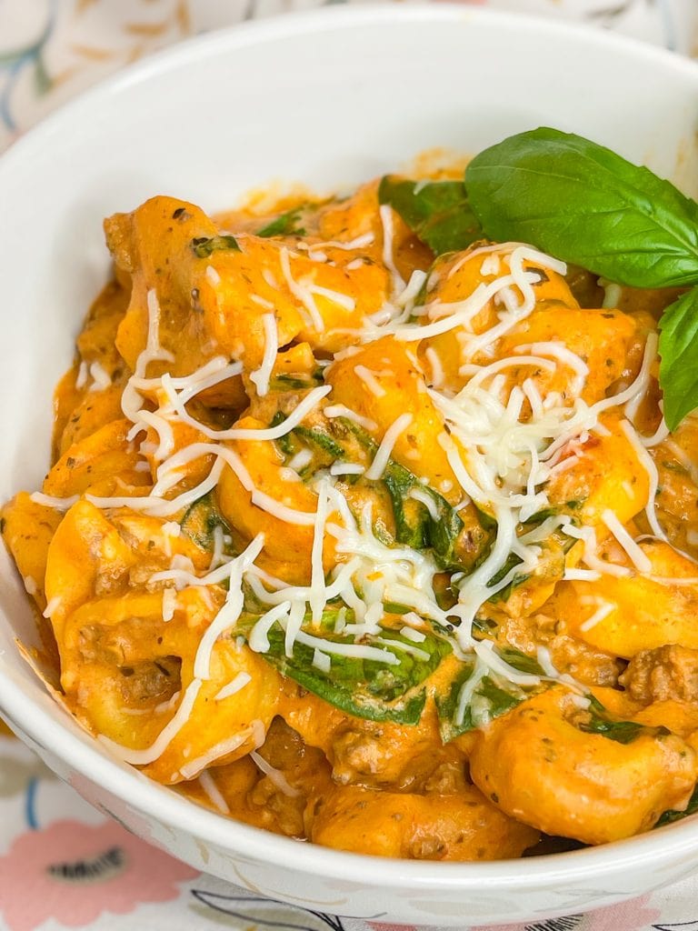 The whole family is going to love this easy weeknight Crock Pot Cheesy Tortellini dinner. It's creamy, rich and filling with tortellini, cream cheese, a hearty meat sauce and spinach.