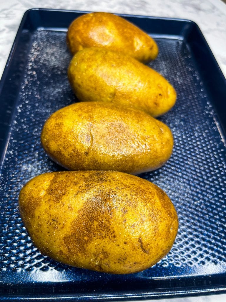 These super Easy Baked Potatoes are minimal effort, a few ingredients and result in a crispy skin, tender inside oven, flavorful baked potato. The perfect accompaniment to any dish or enjoy these as the star of mealtime.