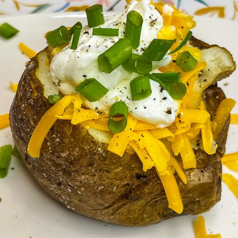 These super Easy Baked Potatoes are minimal effort, a few ingredients and result in a crispy skin, tender inside oven, flavorful baked potato. The perfect accompaniment to any dish or enjoy these as the star of mealtime.