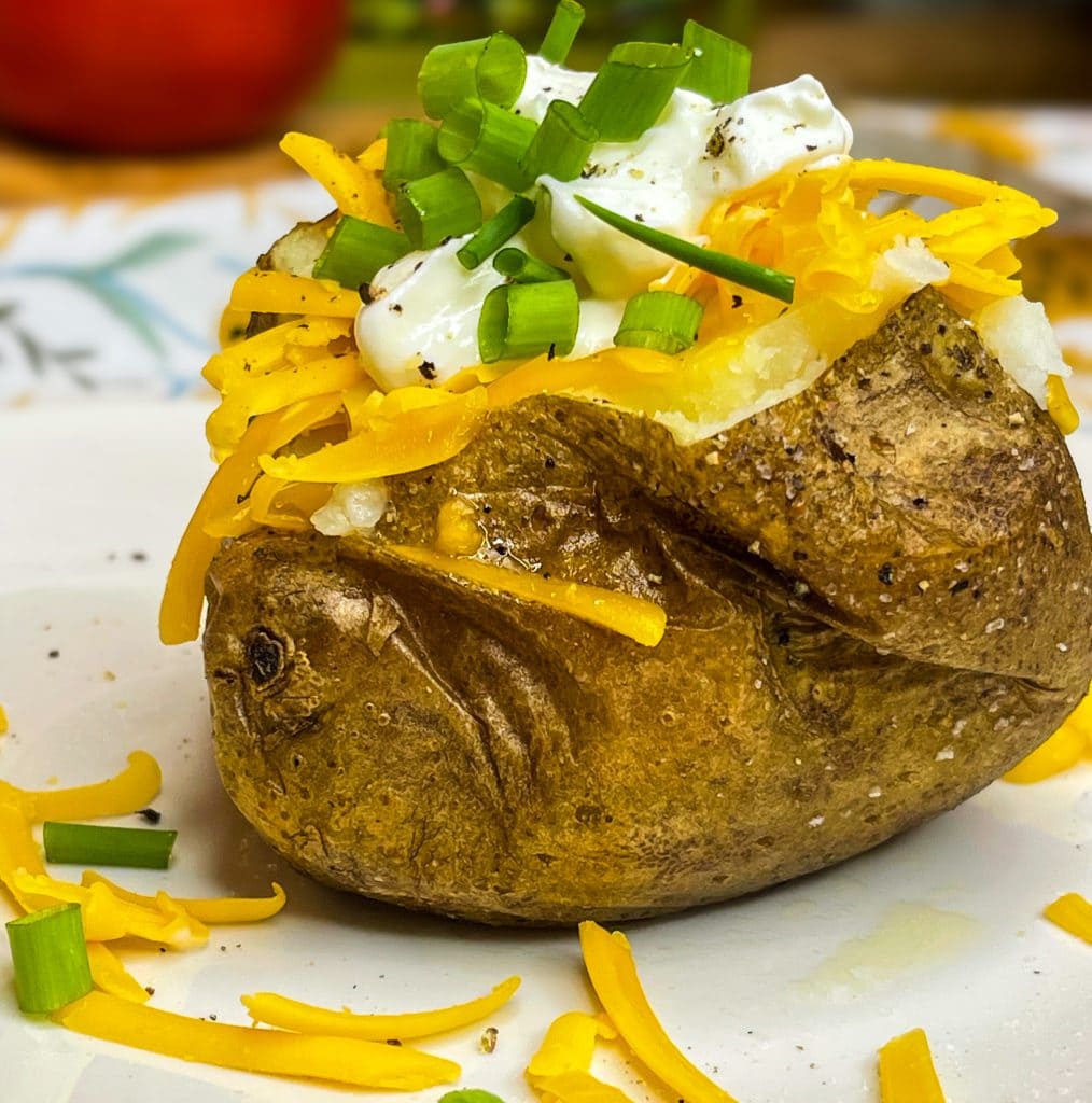 These super Easy Baked Potatoes are minimal effort, a few ingredients and result in a crispy skin, tender inside oven, flavorful baked potato. The perfect accompaniment to any dish or enjoy these as the star of mealtime.