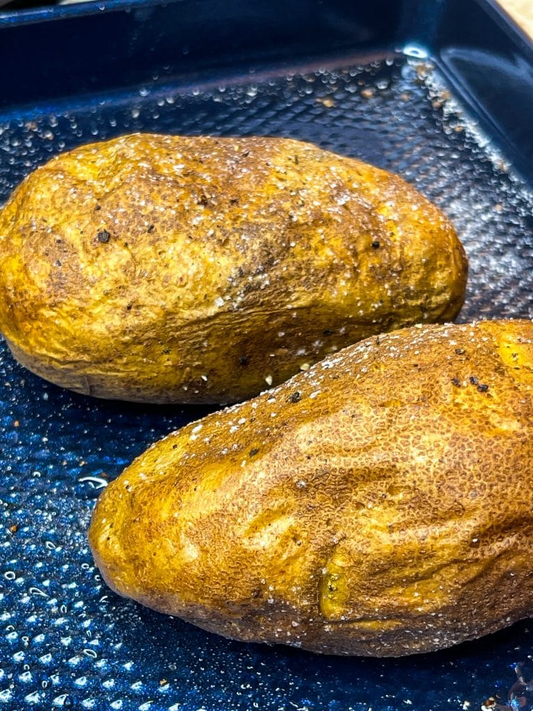 These super Easy Baked Potatoes are minimal effort, a few ingredients and result in a crispy skin, tender inside oven, flavorful baked potato. The perfect accompaniment to any dish or enjoy these as the star of mealtime.