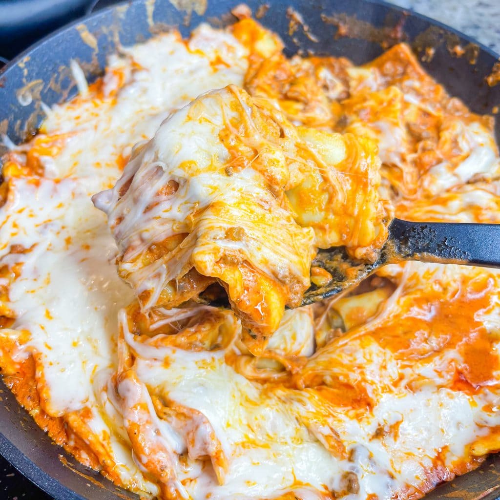 Dinner all in one skillet is the holy grail of meals and this One Pan Cheesy Ravioli is no exception! It's quick, easy, comforting, and best of all-super cheesy. Your family will gobble it up. 