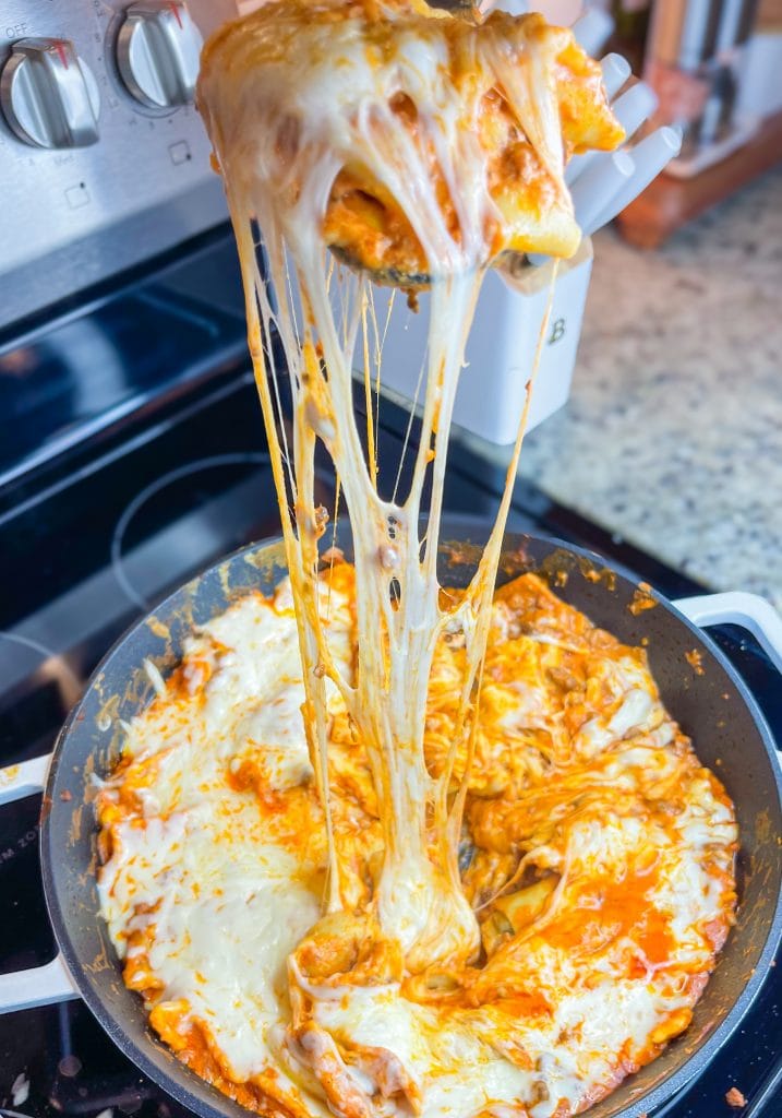 Dinner all in one skillet is the holy grail of meals and this One Pan Cheesy Ravioli is no exception! It's quick, easy, comforting, and best of all-super cheesy. Your family will gobble it up.