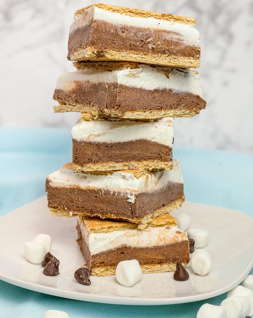 Glide through the lazy days of summer with these refreshing Frozen S'mores bars. These cool treats are made with graham crackers, chocolate pudding, marshmallow fluff, cream cheese, and whipped cream. Perfect for any summer occasion!