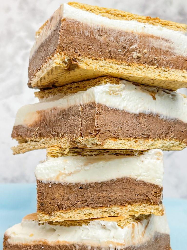 Glide through the lazy days of summer with these refreshing Frozen S'mores bars. These cool treats are made with graham crackers, chocolate pudding, marshmallow fluff, cream cheese, and whipped cream. Perfect for any summer occasion!