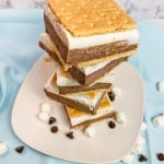 Glide through the lazy days of summer with these refreshing Frozen S'mores bars. These cool treats are made with graham crackers, chocolate pudding, marshmallow fluff, cream cheese, and whipped cream. Perfect for any summer occasion!