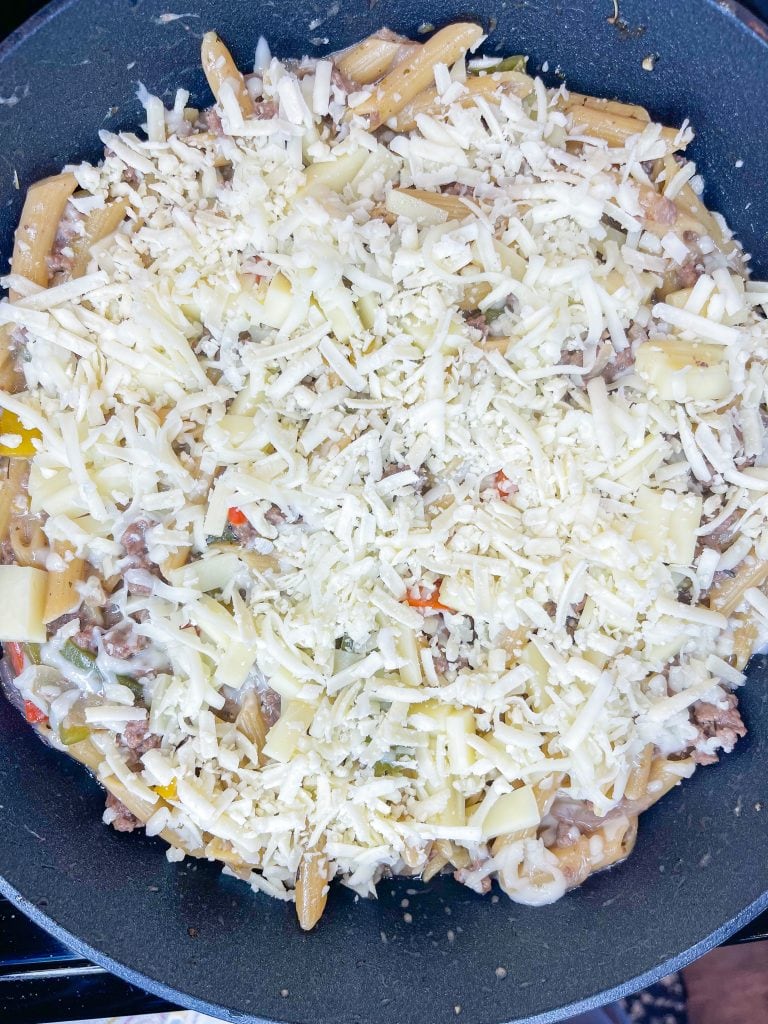 This One Pan Cheesesteak Pasta is filled with ground beef, peppers, onions, penne pasta, and of course, cheese! It's made all in one pan for an easy, family friendly weeknight dinner.