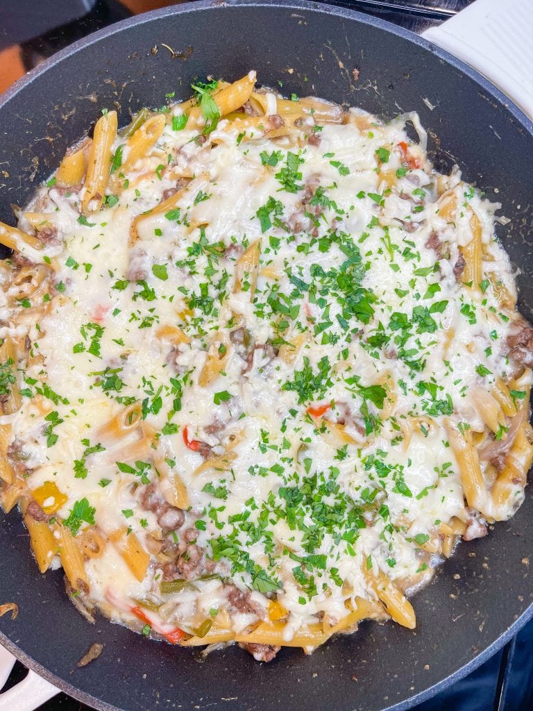 This One Pan Cheesesteak Pasta is filled with ground beef, peppers, onions, penne pasta, and of course, cheese! It's made all in one pan for an easy, family friendly weeknight dinner.