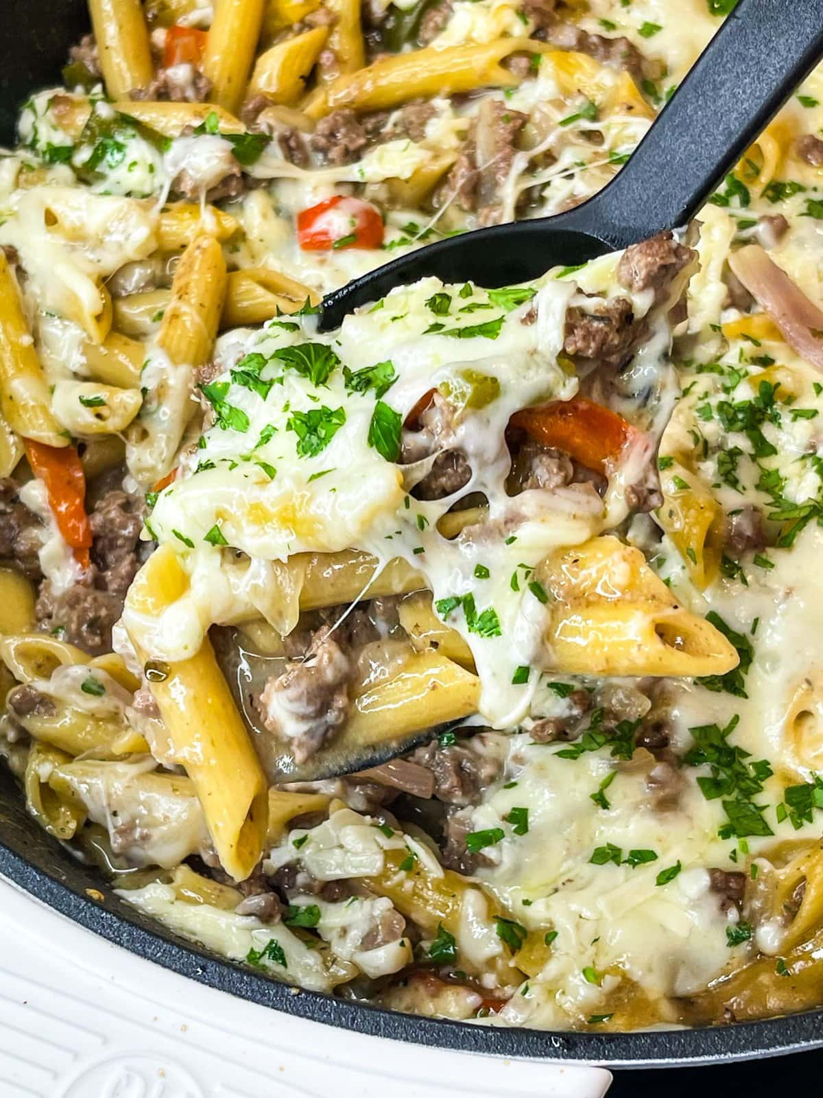 This One Pan Cheesesteak Pasta is filled with ground beef, peppers, onions, penne pasta, and of course, cheese! It's made all in one pan for an easy, family friendly weeknight dinner.