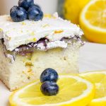 Blueberry Lemon Poke Cake is a refreshing treat great for any time of the year. It's a lemon spiked cake mix topped with creamy lemon pudding, blueberry pie filling and Cool Whip. Easy and delicious!