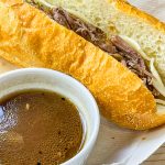 Slow Cooker French Dip Sandwiches are juicy, beefy sandwiches that start with a chuck roast and slow cooked all day that results in a tender beef sandwich with melty cheese on a hearty hoagie bun.