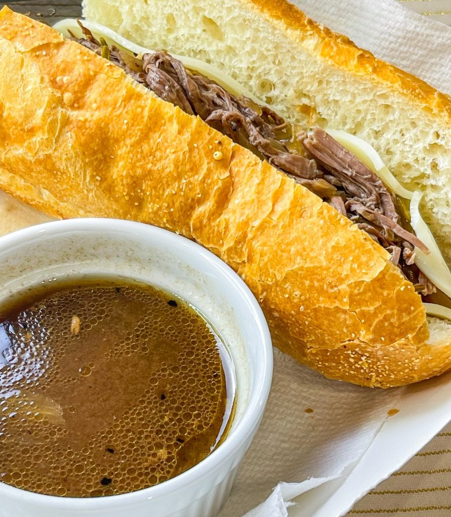 Slow Cooker French Dip Sandwiches are juicy, beefy sandwiches that start with a chuck roast and slow cooked all day that results in a tender beef sandwich with melty cheese on a hearty hoagie bun.