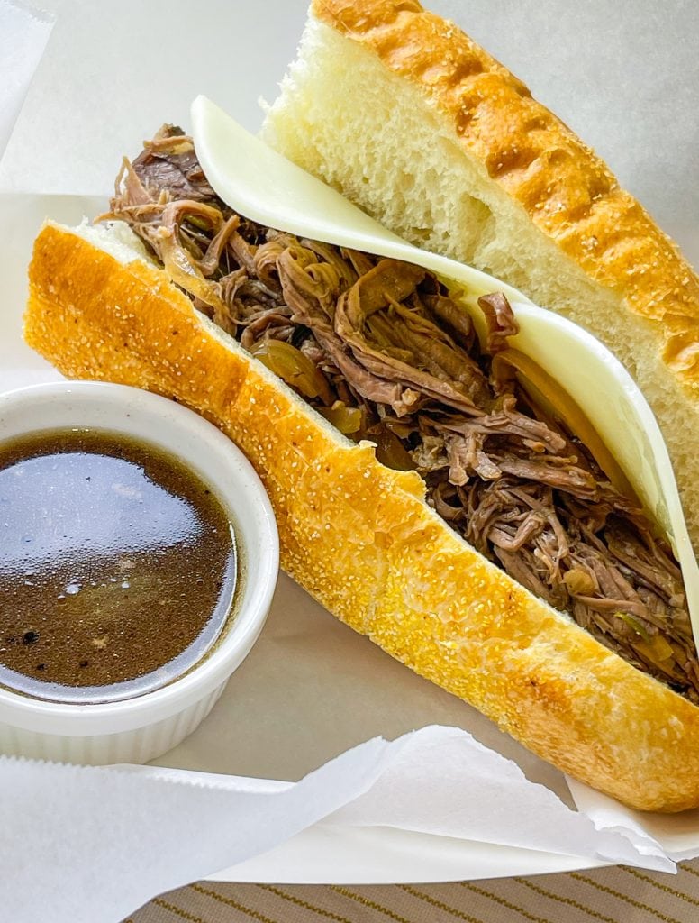 Slow Cooker French Dip Sandwiches are juicy, beefy sandwiches that start with a chuck roast and slow cooked all day that results in a tender beef sandwich with melty cheese on a hearty hoagie bun.