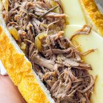 Slow Cooker French Dip Sandwiches are juicy, beefy sandwiches that start with a chuck roast and slow cooked all day that results in a tender beef sandwich with melty cheese on a hearty hoagie bun.