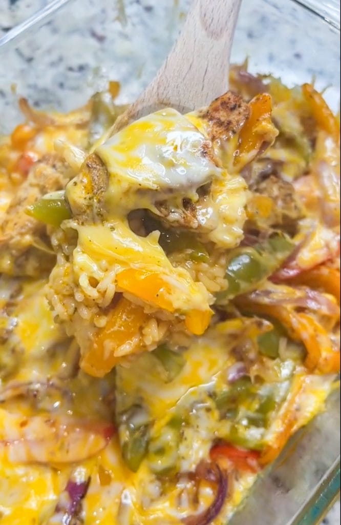 Chicken Fajita Casserole is everything you love about fajitas in a family friendly, one dish casserole. It's a super easy dump-and-bake recipe with rice, bell peppers, onions, fajita seasoned chicken, and melty cheese.