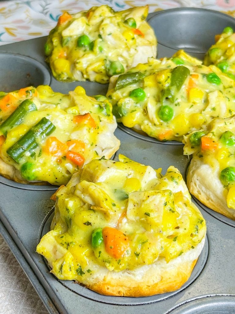 Mini Chicken Pot Pies are delicious little muffins, made with only 4 main ingredients: refrigerated biscuit dough, rotisserie chicken, frozen mixed vegetables, and cream of chicken soup. These delicious pies make a kid-friendly, quick, weeknight dinner!