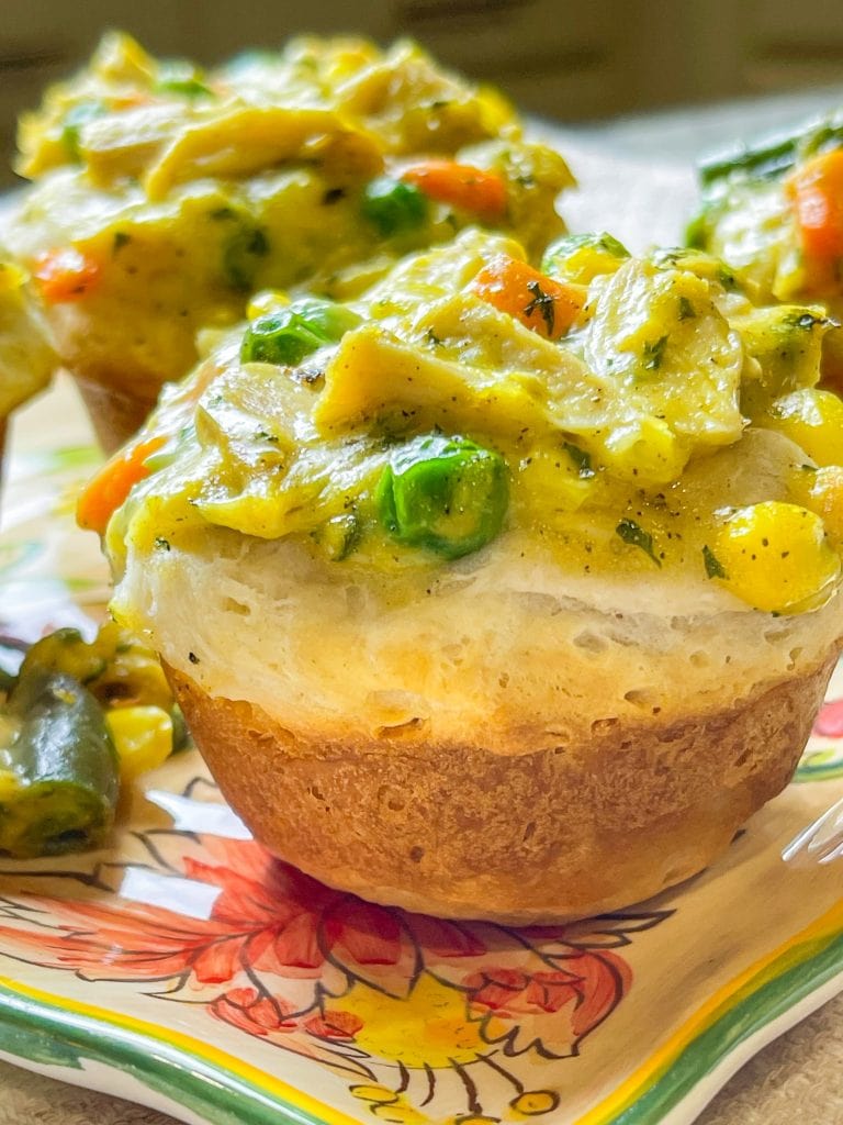 Mini Chicken Pot Pies are delicious little muffins, made with only 4 main ingredients: refrigerated biscuit dough, rotisserie chicken, frozen mixed vegetables, and cream of chicken soup. These delicious pies make a kid-friendly, quick, weeknight dinner!