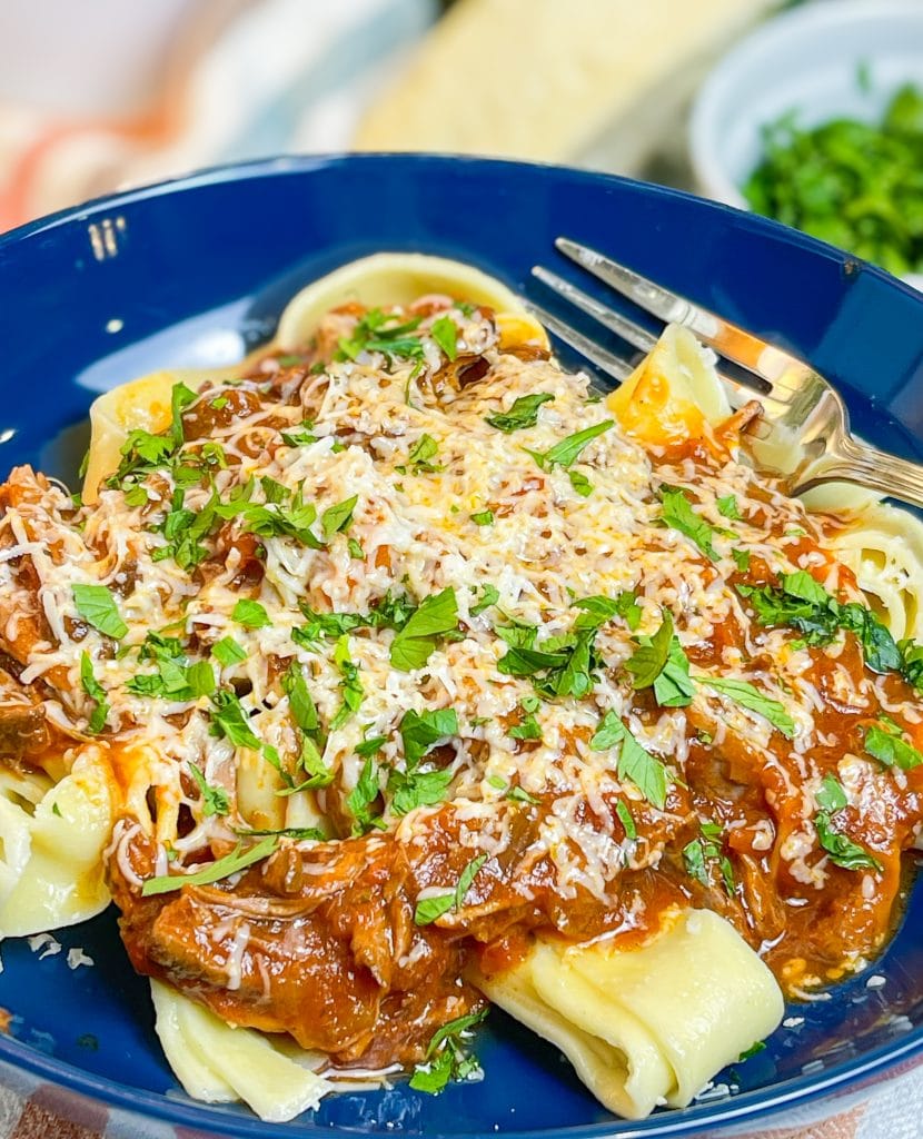 Slow Cooker Beef Ragu is made with chuck roast, which is usually an inexpensive cut of meat and readily available. The roast is quick seared to lock in flavor and combined with red wine, tomatoes, carrots, garlic, onions, and celery before being cooked low and slow all day. The meat just falls apart and the sauce is robust and bold; exactly what you want on a cold fall or winter night. Serve the shredded beef with the tomato sauce over a big bowl of pappardelle or egg noodles along with a side of crusty bread and you have a meal to warm your family on a chilly night.