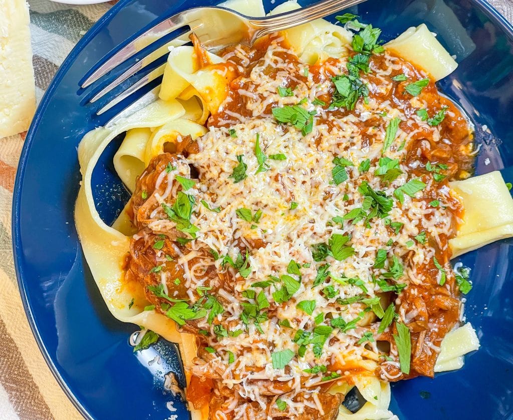 Slow Cooker Beef Ragu is made with chuck roast, which is usually an inexpensive cut of meat and readily available. The roast is quick seared to lock in flavor and combined with red wine, tomatoes, carrots, garlic, onions, and celery before being cooked low and slow all day.

The meat just falls apart and the sauce is robust and bold; exactly what you want on a cold fall or winter night. Serve the shredded beef with the tomato sauce over a big bowl of pappardelle or egg noodles along with a side of crusty bread and you have a meal to warm your family on a chilly night.