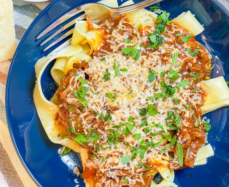 Slow Cooker Beef Ragu is made with chuck roast, which is usually an inexpensive cut of meat and readily available. The roast is quick seared to lock in flavor and combined with red wine, tomatoes, carrots, garlic, onions, and celery before being cooked low and slow all day. The meat just falls apart and the sauce is robust and bold; exactly what you want on a cold fall or winter night. Serve the shredded beef with the tomato sauce over a big bowl of pappardelle or egg noodles along with a side of crusty bread and you have a meal to warm your family on a chilly night.