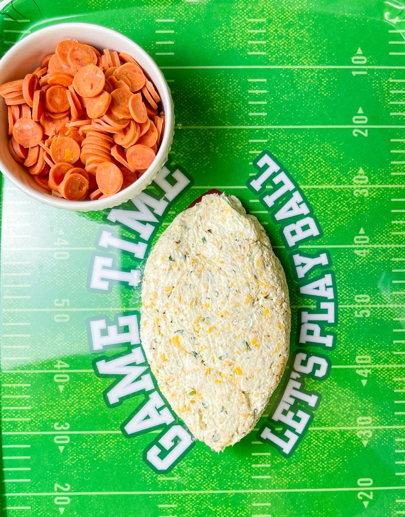 This is the easiest dip to throw together, even last minute! Football Cheese Dip is made with simple panty ingredients: cream cheese, cheddar cheese, and seasonings, but is elevated with the addition of mini pepperoni to resemble a football. Your family and guests will rave! This recipe is easily doubled or tripled for a large crowd and can be prepared a day or two before serving so on game day you can have fun without the hassle.