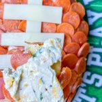 This is the easiest dip to throw together, even last minute! Football Cheese Dip is made with simple panty ingredients: cream cheese, cheddar cheese, and seasonings, but is elevated with the addition of mini pepperoni to resemble a football. Your family and guests will rave! This recipe is easily doubled or tripled for a large crowd and can be prepared a day or two before serving so on game day you can have fun without the hassle.