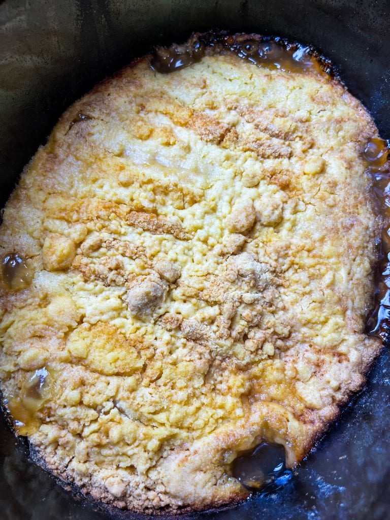 You'll love this Crock Pot Peach Cobbler because it's only 3 simple ingredients, it's the perfect dessert for any occasion, and it's a cinch to put together. This crock pot peach cobbler is my go-to dessert for a potluck for family gathering when I'm short on time. It's only 3 ingredients! The ingredients are peach pie filling, yellow cake mix, and butter. That's it! It takes literally 5 minutes to prep, it's inexpensive to make and it feeds a lot of people.