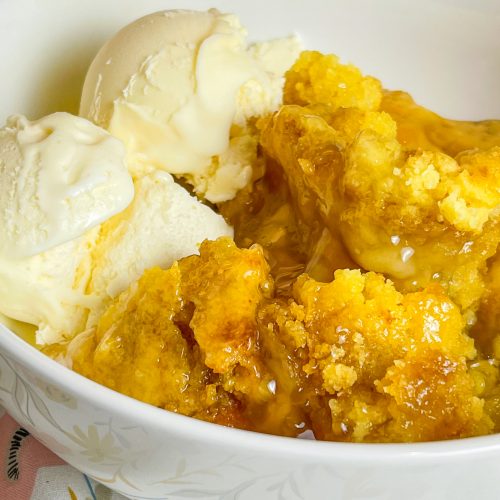 You'll love this Crock Pot Peach Cobbler because it's only 3 simple ingredients, it's the perfect dessert for any occasion, and it's a cinch to put together. This crock pot peach cobbler is my go-to dessert for a potluck for family gathering when I'm short on time. It's only 3 ingredients! The ingredients are peach pie filling, yellow cake mix, and butter. That's it! It takes literally 5 minutes to prep, it's inexpensive to make and it feeds a lot of people.