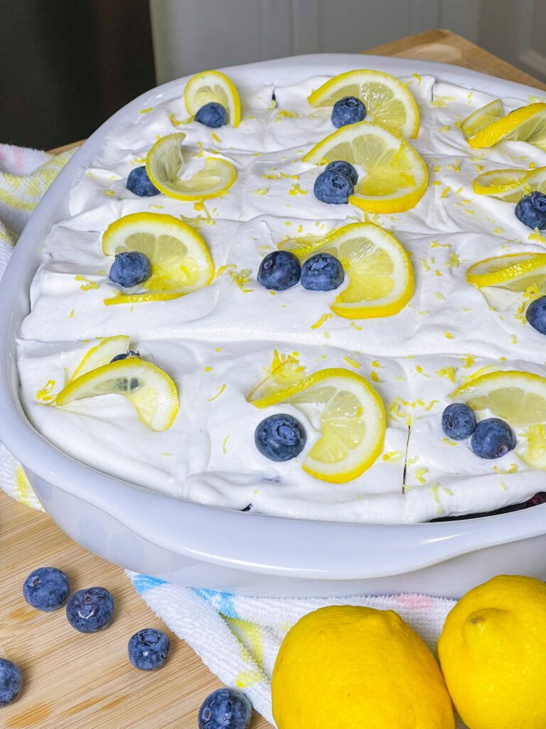 This Blueberry Lemon Poke Cake is a bright and refreshing dessert that’s as beautiful as it is delicious! It starts with a soft and fluffy white cake, infused with tangy lemon pudding that soaks into every bite, adding a burst of citrus flavor. A luscious layer of blueberry pie filling follows, bringing just the right balance of sweetness and fruitiness. Finally, it’s topped with a light and creamy whipped topping, making every forkful a dreamy combination of flavors and textures. Perfect for spring, summer, or anytime you’re craving a dessert that’s equal parts sweet, zesty, and irresistibly moist!