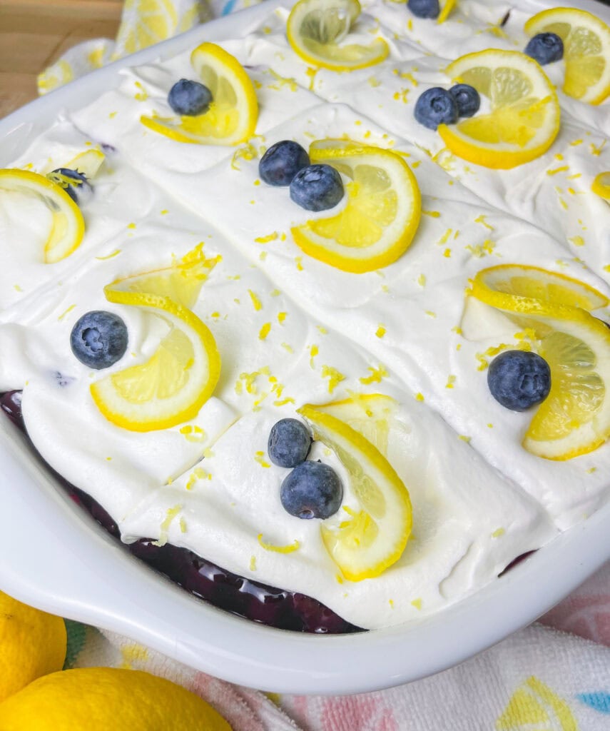 This Blueberry Lemon Poke Cake is a bright and refreshing dessert that’s as beautiful as it is delicious! It starts with a soft and fluffy white cake, infused with tangy lemon pudding that soaks into every bite, adding a burst of citrus flavor. A luscious layer of blueberry pie filling follows, bringing just the right balance of sweetness and fruitiness. Finally, it’s topped with a light and creamy whipped topping, making every forkful a dreamy combination of flavors and textures. Perfect for spring, summer, or anytime you’re craving a dessert that’s equal parts sweet, zesty, and irresistibly moist!